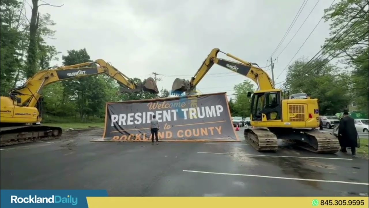 Massive banner near RCC welcomes President Trump at the Lev Teen Center parking lot.