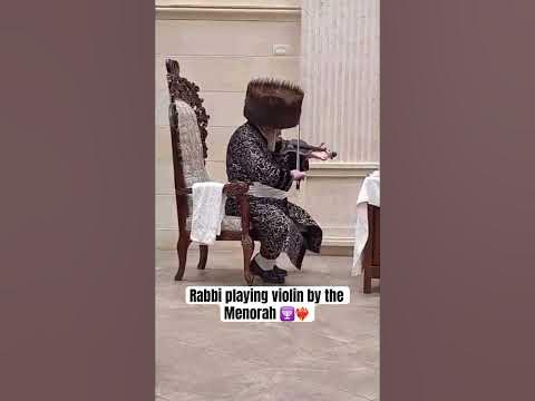 Premishlan Rabbi playing violin by the Menorah 🕎❤️‍🔥
