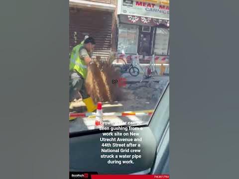 Water main gushing on New Utrecht Ave after National Grid crew struck pipe during work.