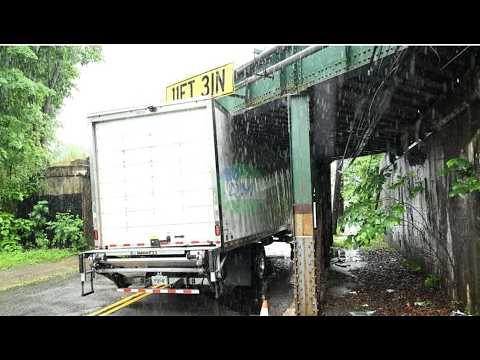 Overheight truck gets stuck beneath the Smith Clove Road bridge after ignoring clearance.