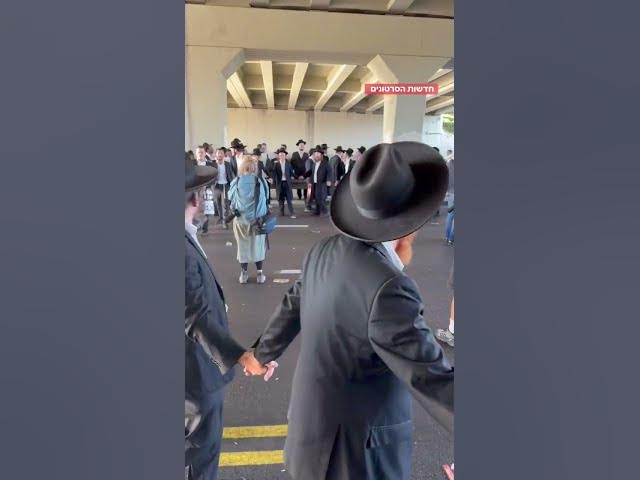 Ultra-Orthodox man blocking highway 4 near Bnei Brak in Protest of the IDF Draft