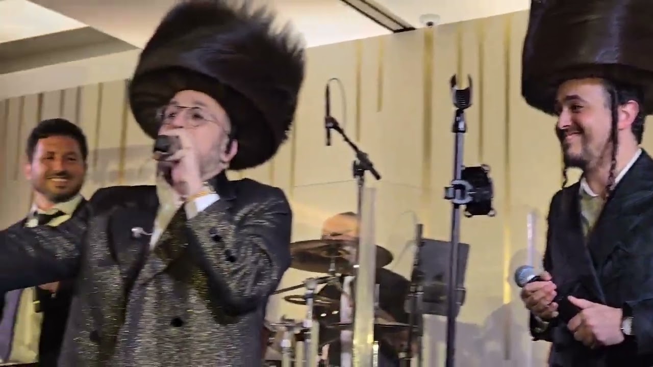 Lipa Schmeltzer and Eli Levin singing at the Hershkowitz Hachnosas Sefer Torah