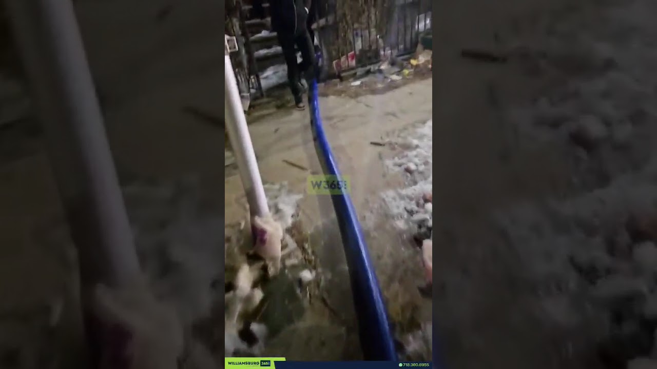 Water is seen gushing forcefully into multiple apartments on Vernon Avenue