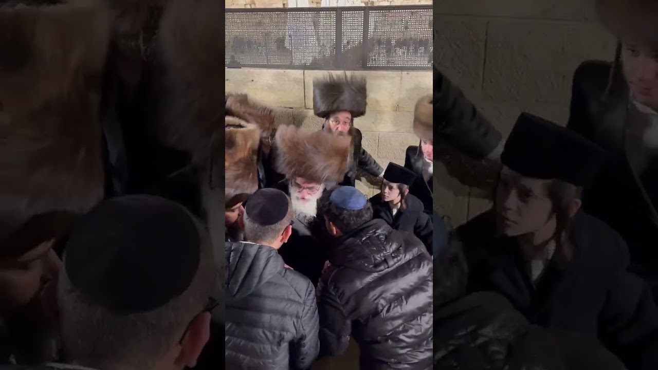 Viznitz Rebbe R Mendel greeting people in his way out from the Kosel
