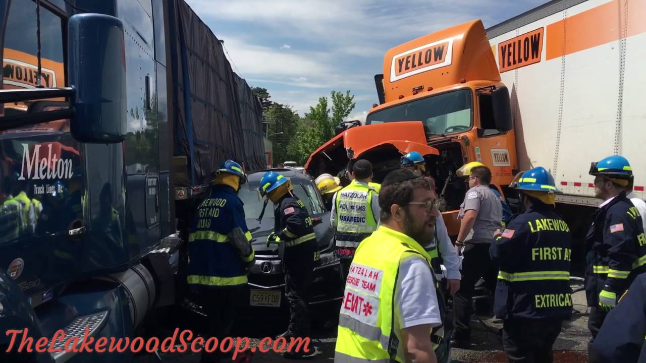 Vehicle pinned between tractor trailers