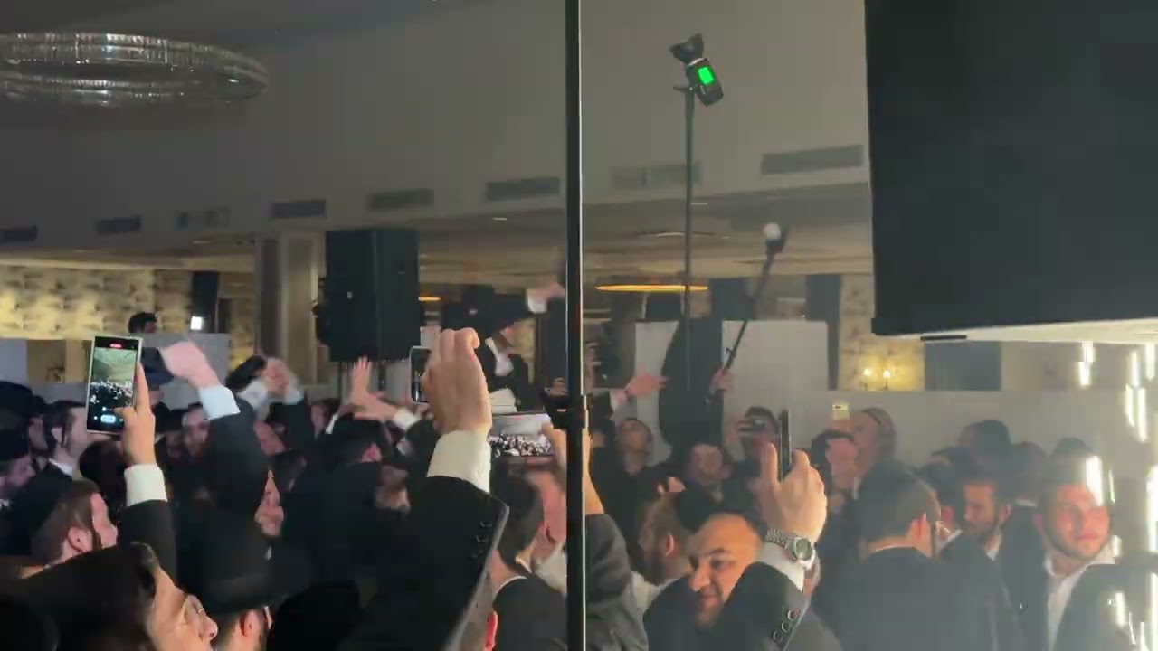 Jewish people dancing while others are capturing the moment on their new iPhone 15
