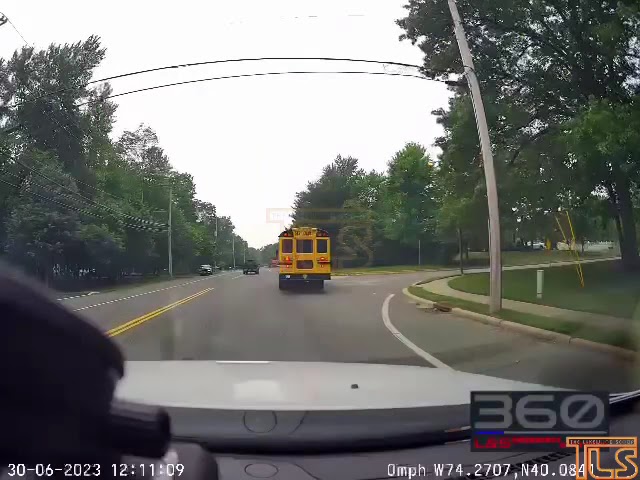 Driver passes school bus in front of cop
