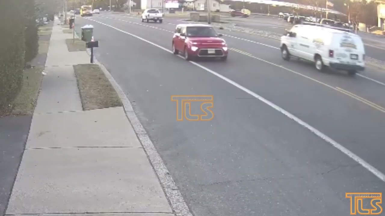 Another vehicle passes school bus letting off a child