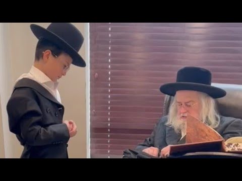 The Grand Rabbi Of Munkatch Is Putting On Tefilin For Famous Child Soloist Meir Rosinger