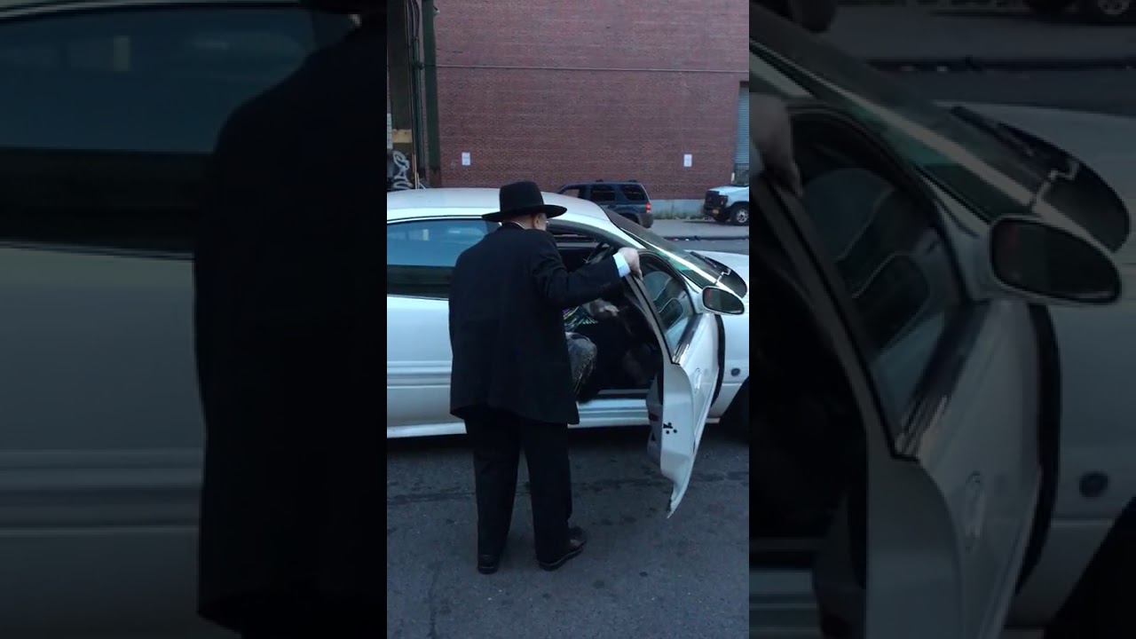 Rav David Feinstein ztz"l helping his Rebbitzen into the car...