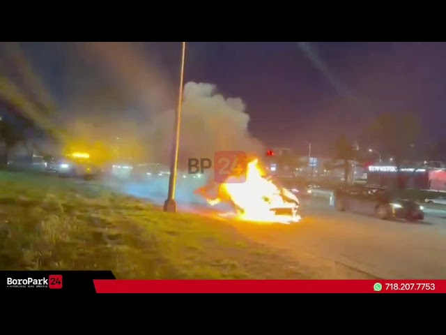 A vehicle engulfed in flames on the Belt Parkway