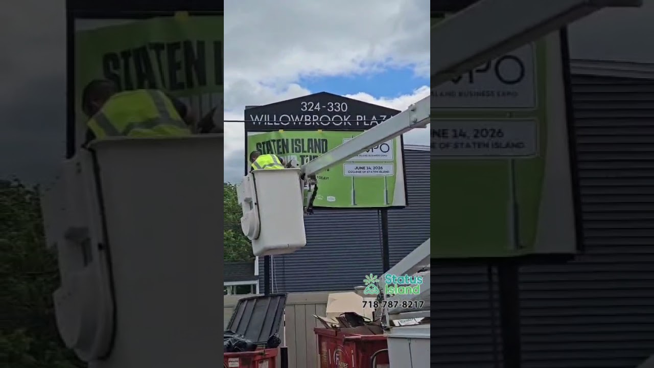 Eruv truck putting up a billboard for the SI expo coming up - Status island