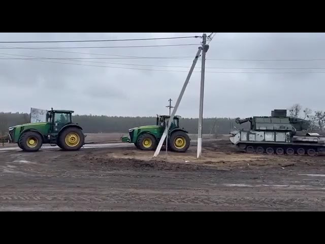 Ukraine Farmer Pulling Away A Russian Tank, With Two Tractors