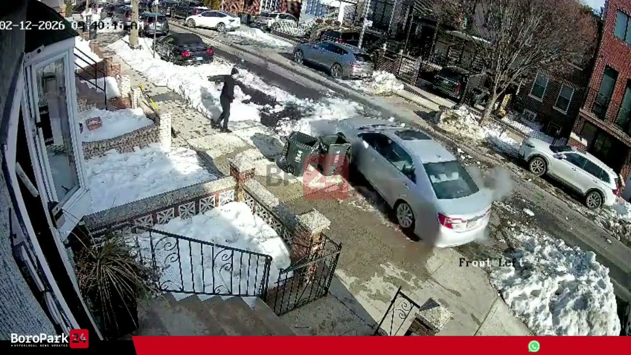 Car hits a parked car in a snowy parking spot and lost control, driving onto the sidewalk.