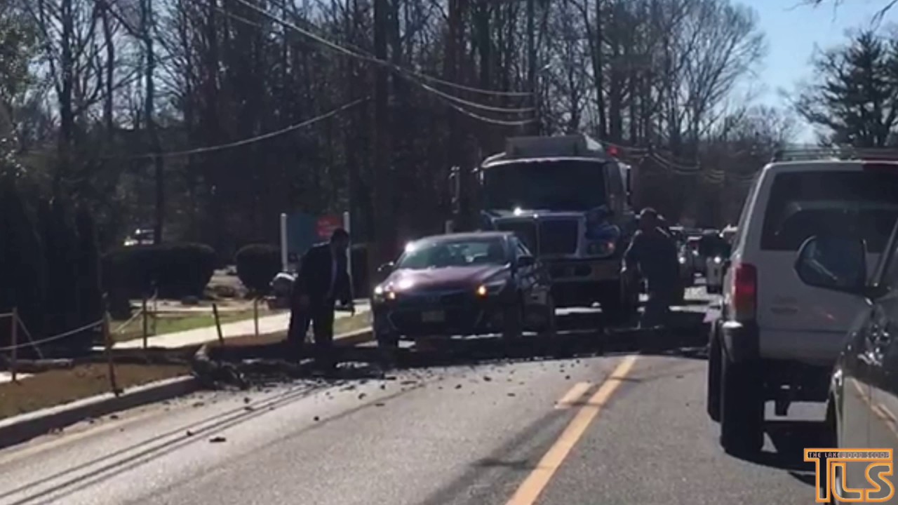 Residents move fallen tree from roadway