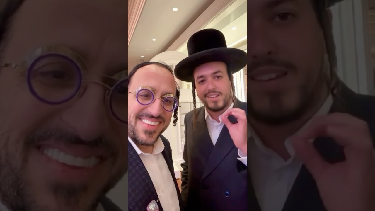 Meilech Braunstein giving a compliment to Lipa Schmeltz on the release of his new album