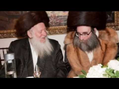 Grand Rabbi of Oshver putting on tfilin with rabbi Pinchus Pinchs Gold