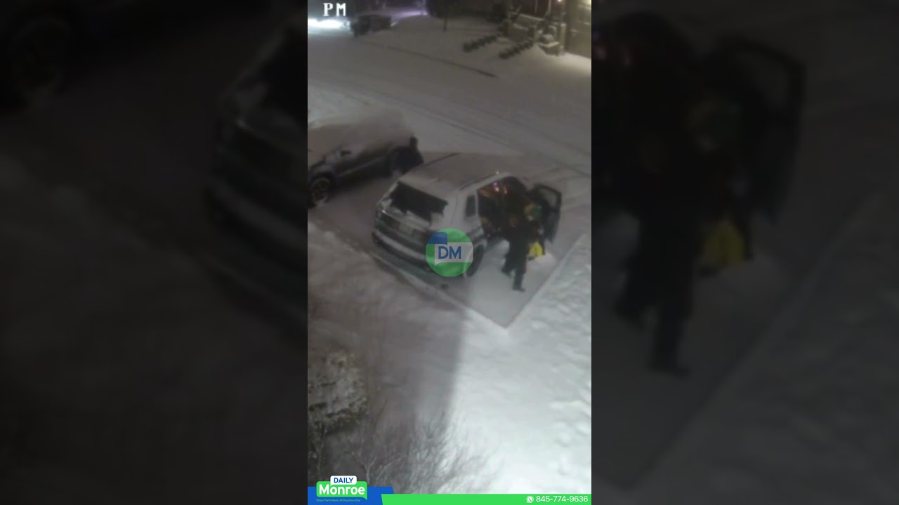 On Rovna Court, a car slid on the snow as passengers stepped out.